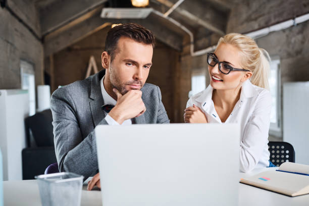 istock Two business people discussing in office. 666991678