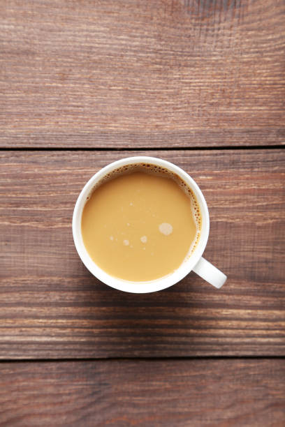 istock Cup of coffee on a brown wooden table 667002096