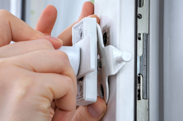 istock Close-up hands of locksmith  installing window limiter on plastic frame. 667006046