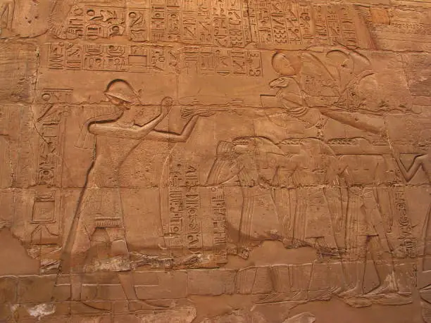Temple of Luxor, Egypt. Relief of Ramses II who is burning incense in front of Amun’s barque.