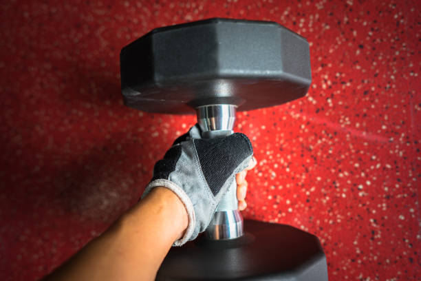 istock Male hand holding metal barbell 667006610