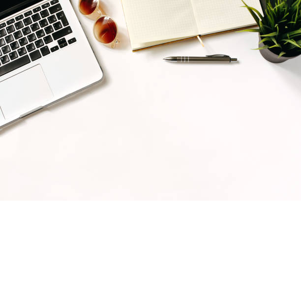 istock Modern home workspace with bright sunglasses, laptop keyboard, green office plant and notebook. White background, top view, flat lay 667009978