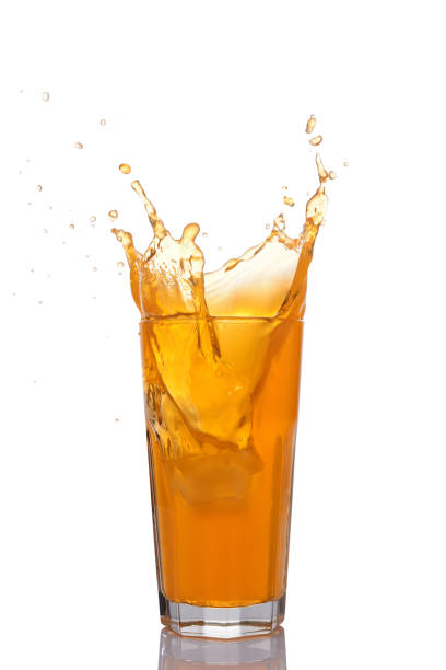 Splash in glass of orange juice with ice isolated on white background