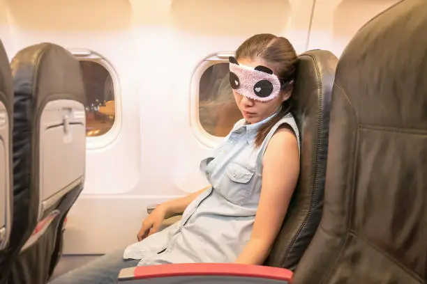 Photo of Asian woman traveller sleeping in the airplane