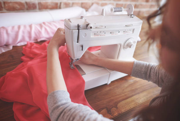 istock Back view of intent seamstress sewing 667020846