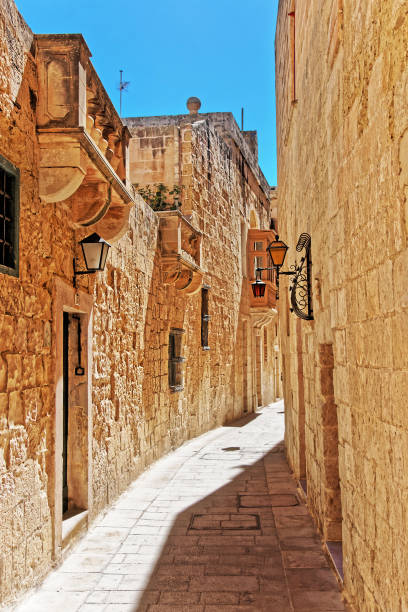 istock Narrow silent street with lanterns in Mdina 667027472