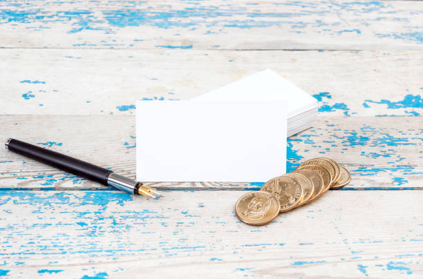 istock Business cards with pen and coins. 667032524