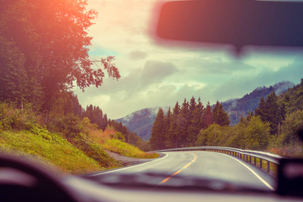 istock View from windscreen. Driving a car on mountain road. Nature Norway 667033000