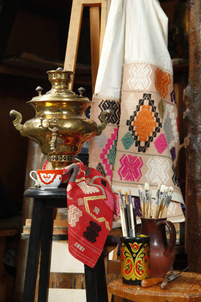 istock Copper traditional Russian samovar on a background of fabric with the national pattern 667037424