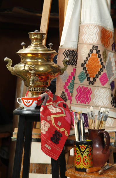 istock Copper traditional Russian samovar on a background of fabric with the national pattern 667037428