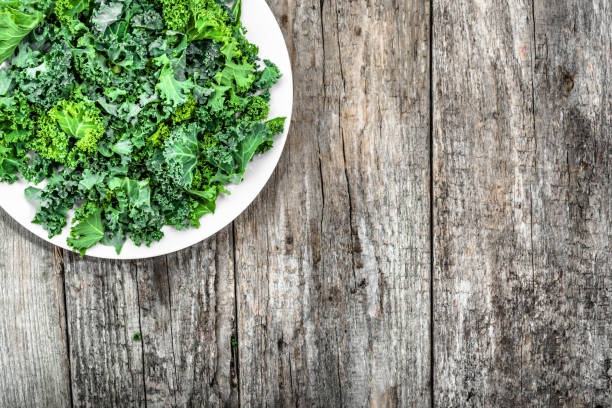 istock Preparing green vegetable chips from leaves of kale sliced on plate, from above, copy space 667039456