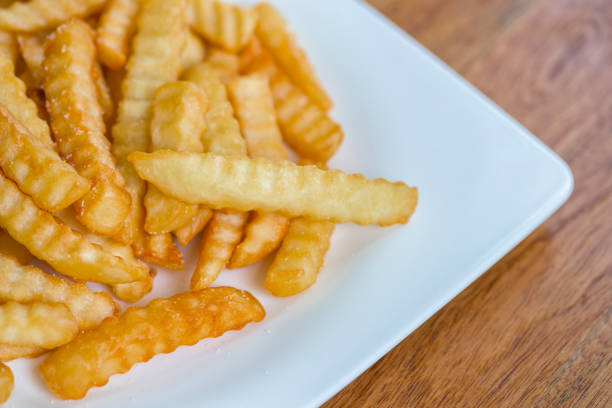 istock French fries on wooden background. 667039996