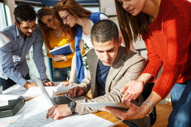 istock Designer and his friends working on new project . 667056702
