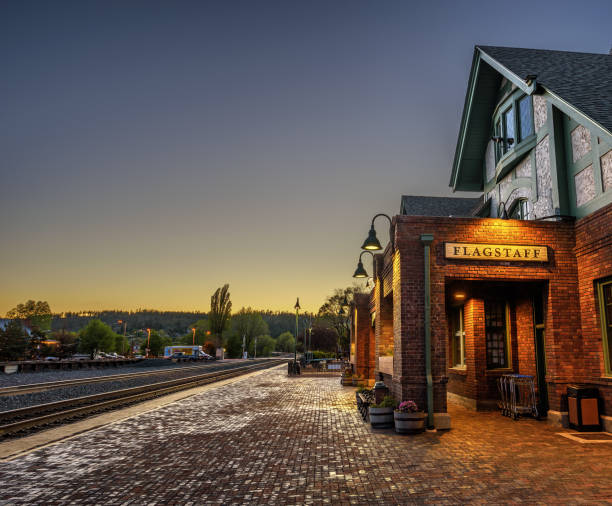 Historic Flagstaff railway station at sunset Flagstaff, Arizona: Historic train station in Flagstaff at sunset. It is located on Route 66 and is formerly known as Atchison, Topeka and Santa Fe Railway depot. Hdr processed. Amtrak stock pictures, royalty-free photos & images