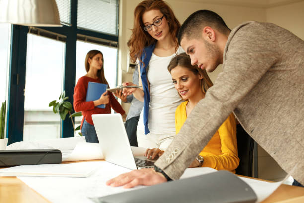 istock Businesswoman and her fellow workers  working on new project 667059022