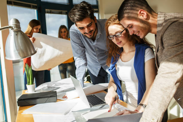 istock Businesswoman and her fellow workers  working on new project 667059334