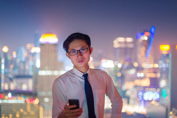 istock Young business man using laptop and digital tablet cityscape background 667063638