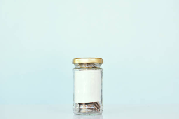istock Close up coin in glass jar ,concept save mon 667063978