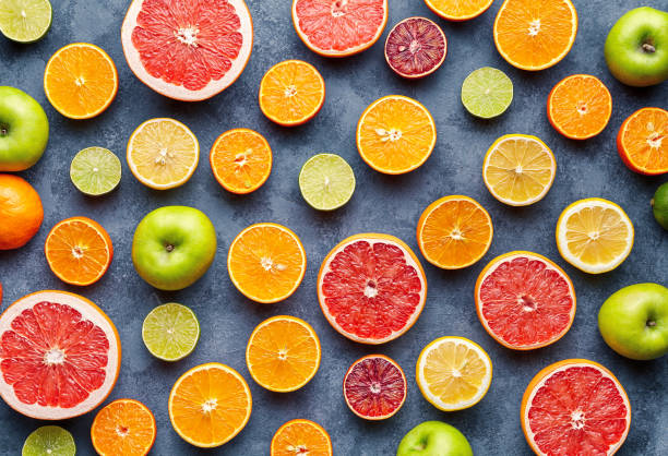istock Citrus fruit pattern on grey concrete table. Fruit food background. Healthy eating. Antioxidant, detox, dieting, clean eating, vegetarian, vegan, fitness or healthy lifestyle concept 667067542