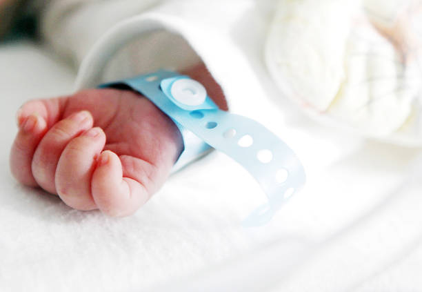 newborn hand newborn hand baby bracelet stock pictures, royalty-free photos & images