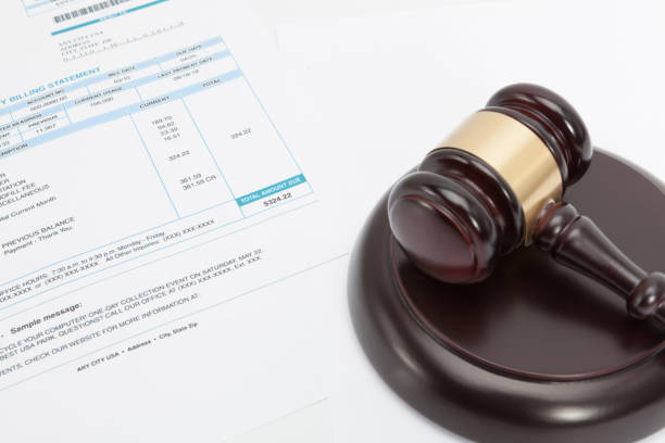 istock Unpaid bill with wooden gavel over it series 667071214