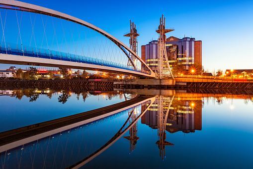 Stock Photo of the Millenium Bridge at Salford Quays in Manchester, England at twilight blue hour.