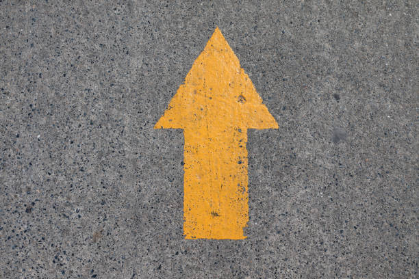 istock Yellow asphalt sign, arrow 667074382