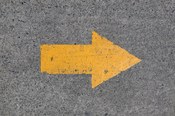 istock Yellow asphalt sign, arrow 667074392