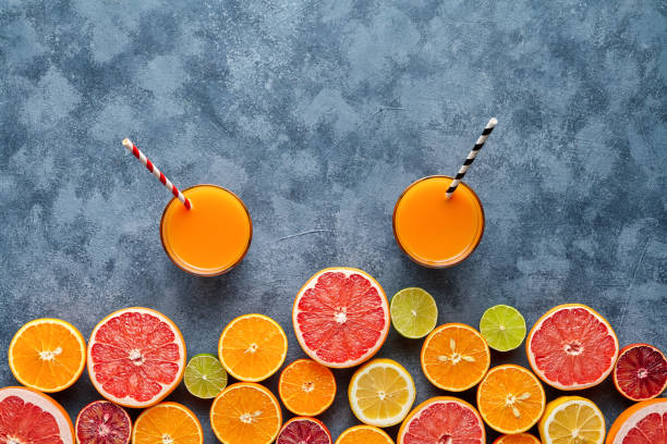 istock Fresh juice or smoothie vitamin c drink in citrus fruits background flat lay on concrete table 667075310