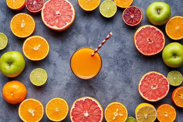 istock Fresh juices or smoothies with citrus fruit, apple, grapefruit on light background. Top view, selective focus. Detox, dieting, clean eating, vegetarian, vegan, fitnes healthy concept 667075664