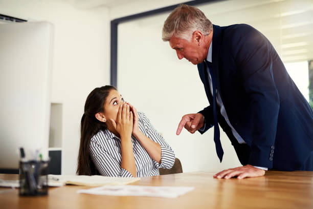 Next time you mess up, you're out! Cropped shot of a businessman reprimanding an employee in an office confrontation photos stock pictures, royalty-free photos & images