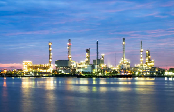 istock river side oil refinery industry plant along twilight morning 667080248