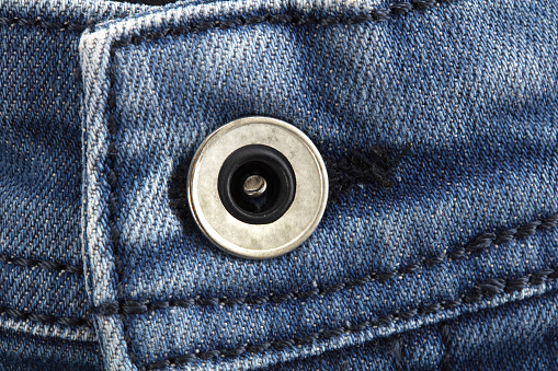 Unbuttoned zipper on old blue jeans. Background and texture