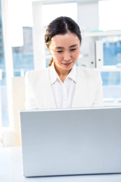 istock Smiling businesswoman working at her desk 667085836