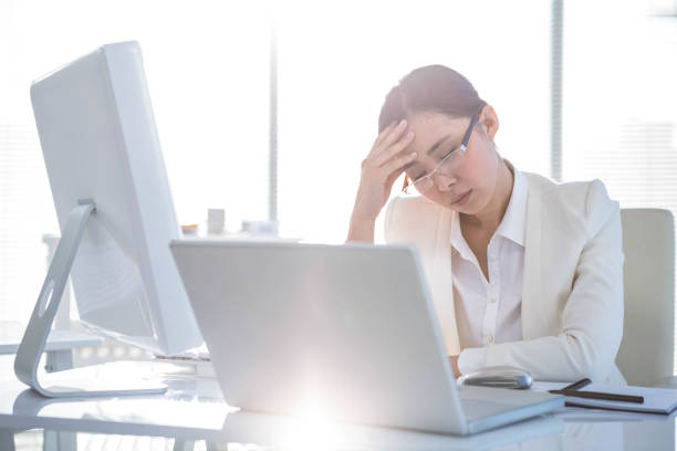 istock Stressed businesswoman working at her desk 667086562