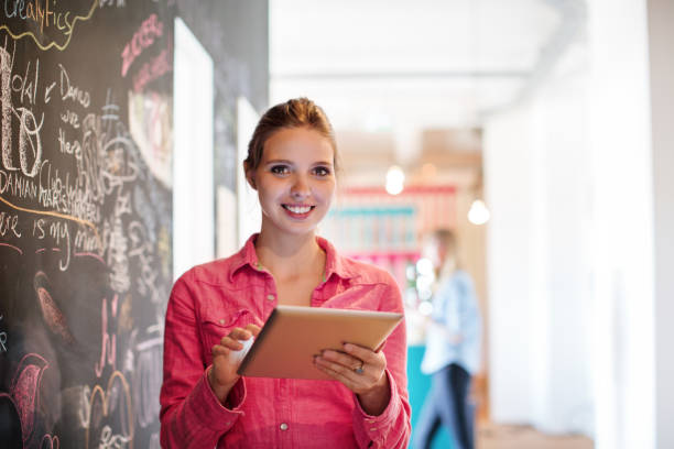 istock Smiling businesswoman holding digital tablet 667095082