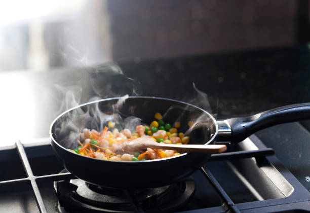 Close-up shot of unrecognizable young chef preparing pasta in restaurant kitchen
