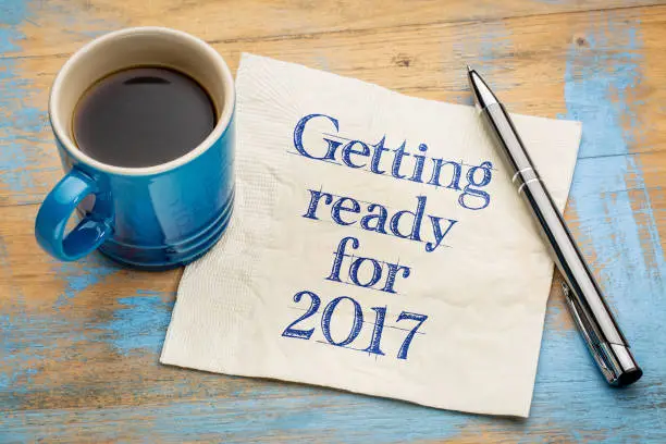 Getting ready for 2017 - handwriting on a napkin with a cup of espresso coffee