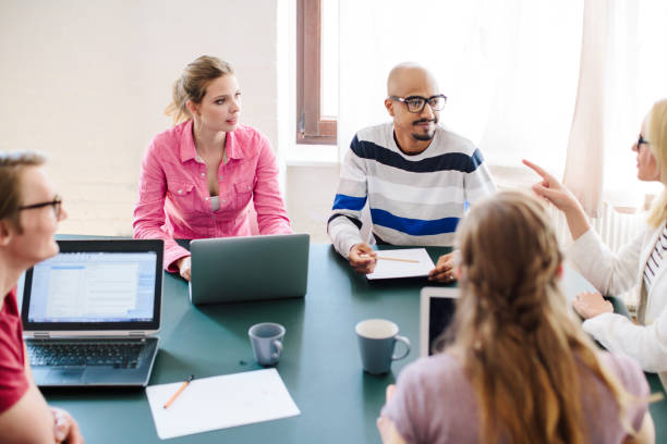istock Businesswoman discussing with colleagues in office 667100392