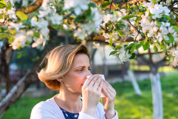 istock Woman sneezing into a tissue 667103808