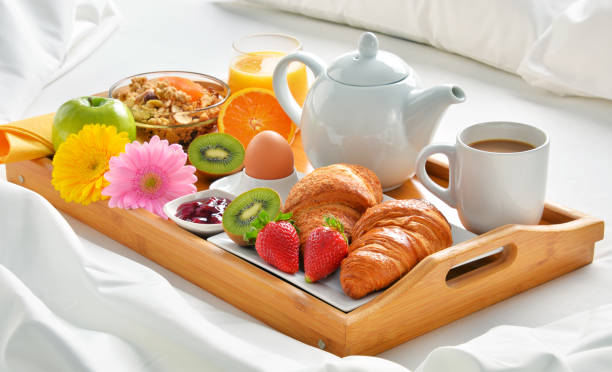 istock Breakfast tray in bed in hotel room 667105980