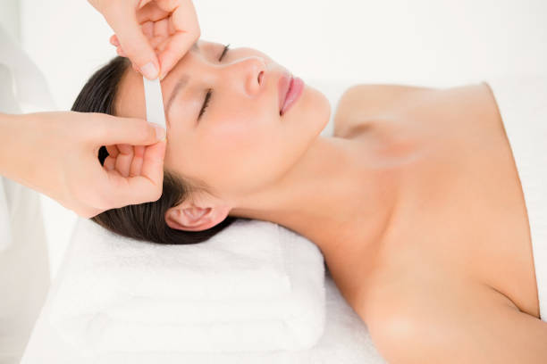 istock Hand waxing beautiful womans eyebrow 667107204