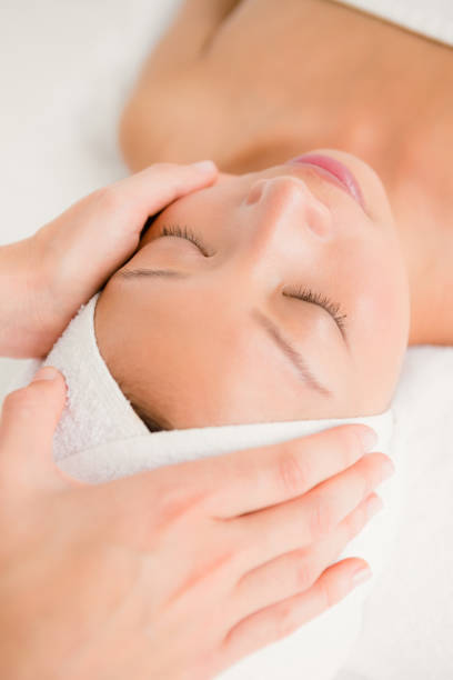 istock Attractive young woman receiving forehead massage 667111136