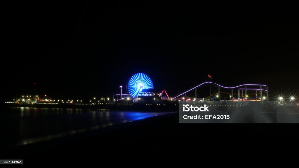 Santa Monica Pier, Los Angeles at night 4k Santa Monica Pier, Los Angeles California USA, long exposure at night shot in 4k high resolution Amusement Park Stock Photo