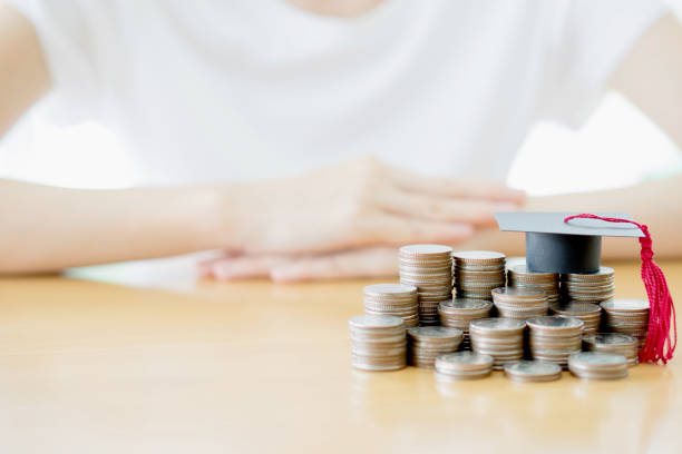 Woman saving education coins Woman saving education coins chevening scholarship stock pictures, royalty-free photos & images