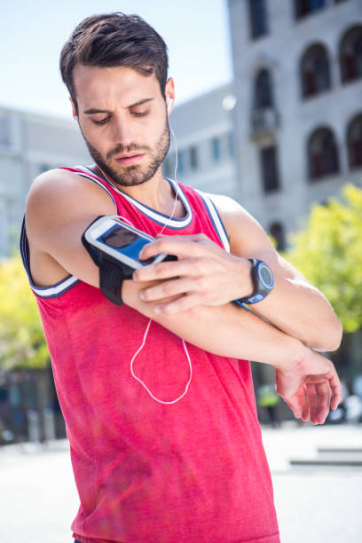 istock Handsome athlete adjusting his armband 667115662