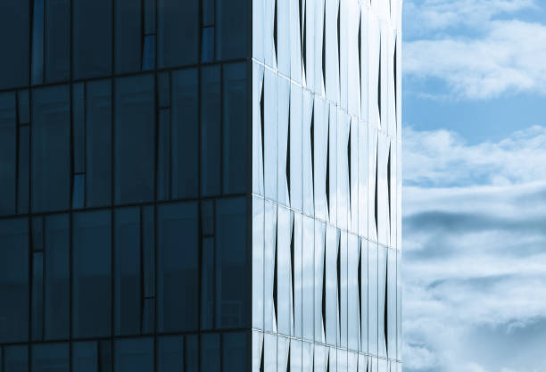 istock Corner of modern office building and cloudy sky 667118522