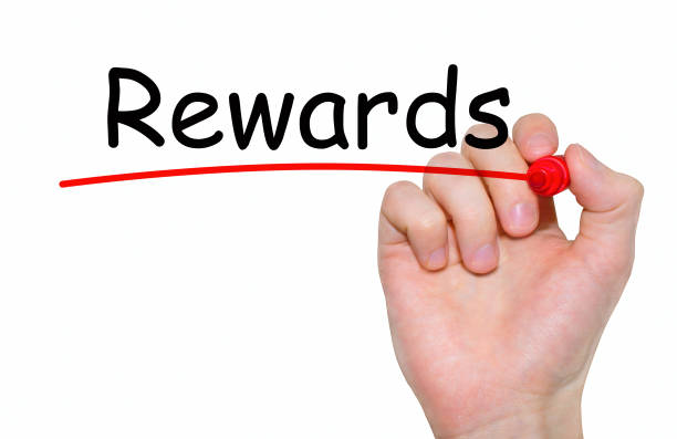 istock Hand writing Rewards with red marker on transparent wipe board. 667119156