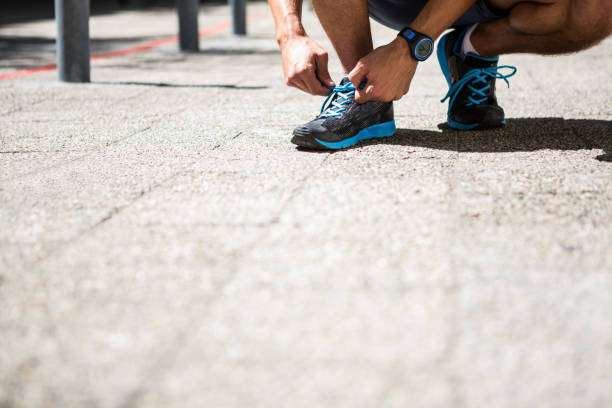 istock Athletic man tying his shoe laces 667119646