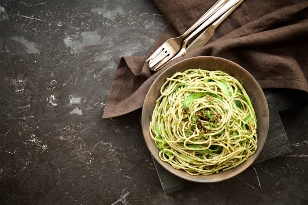 istock Pasta with zucchini and pesto on dark background 667123766